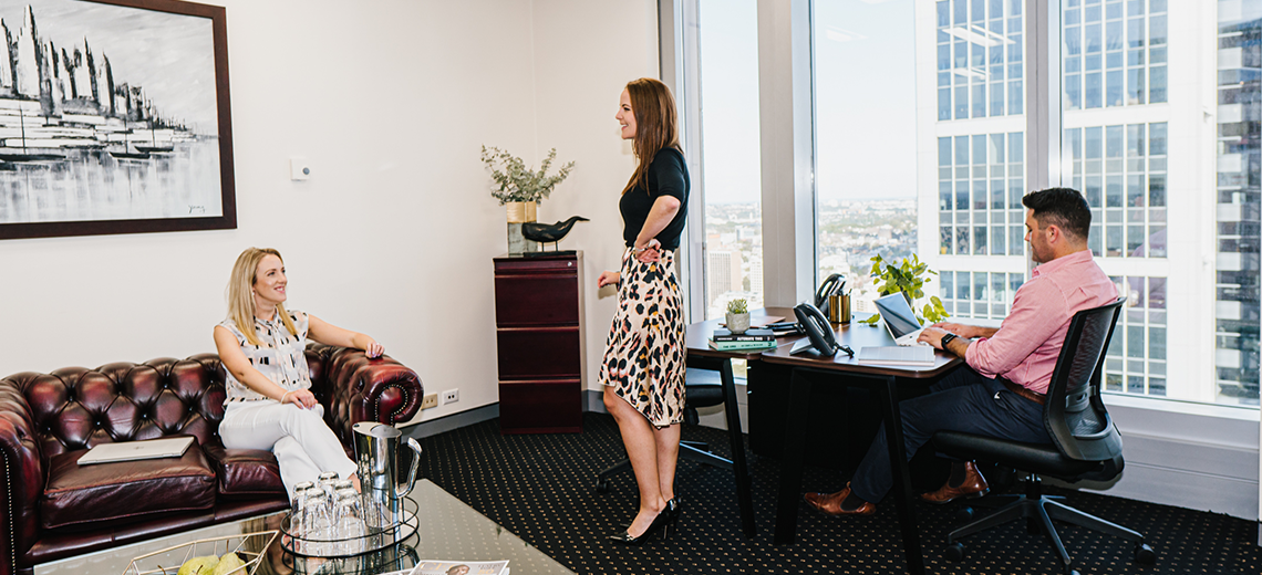 Serviced Office with a view with clients working and brainstorming in a modern, professional environment.