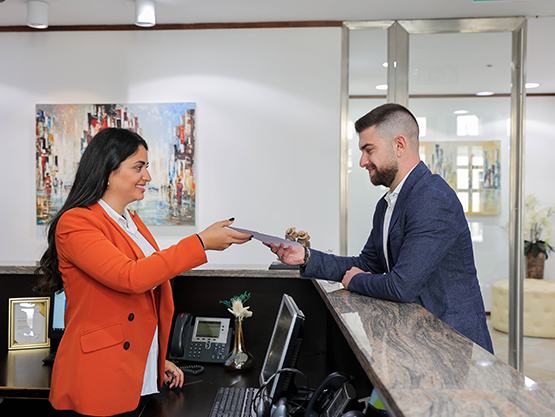 Client receiving his mail from Servcorp dedicated receptionist. Mail & Courier Management.